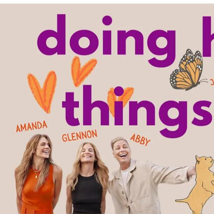 Sadie Freely holding a cup of coffee with neon pink Animal Matters sign above her on brick wall